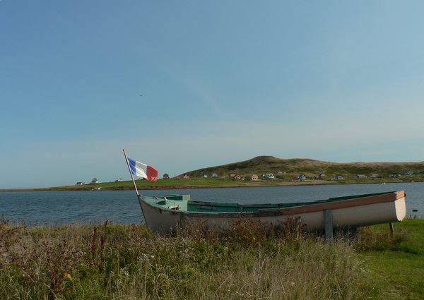 Boat on water; houses across the way