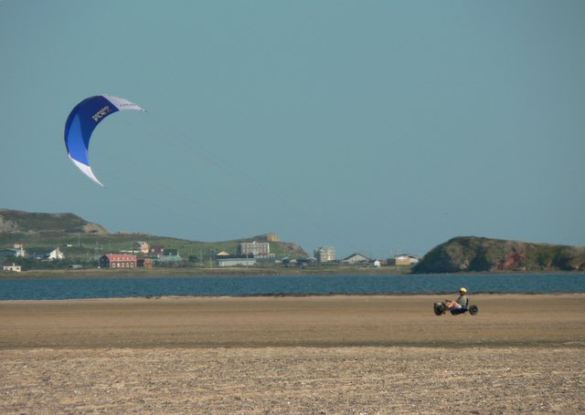 Someone riding a kite buggy